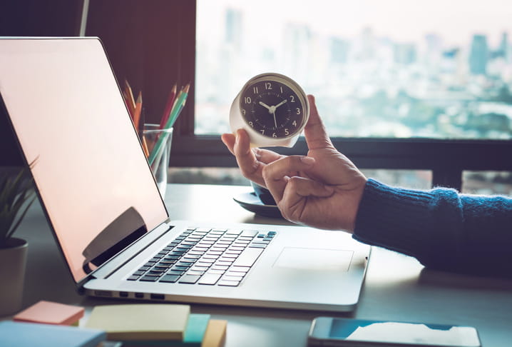 Business concepts with businessman holding clock