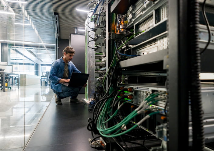 Computer technician fixing a network server