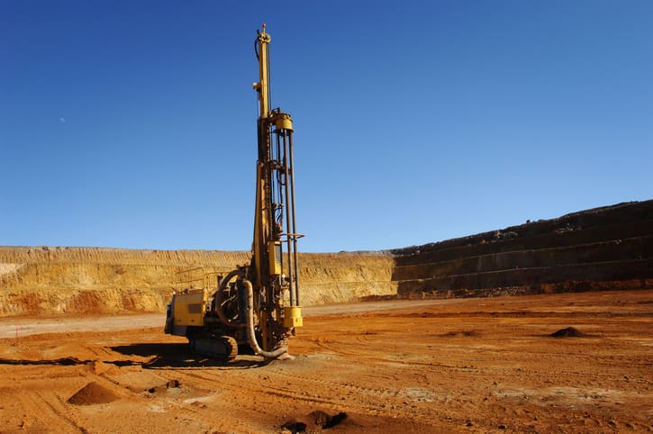 Mining drill rig boring blast holes