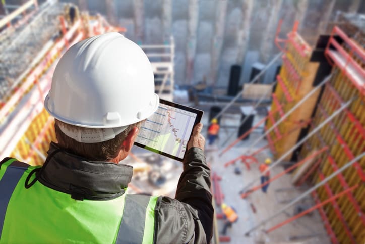 architect construction worker on construction site with tablet computer