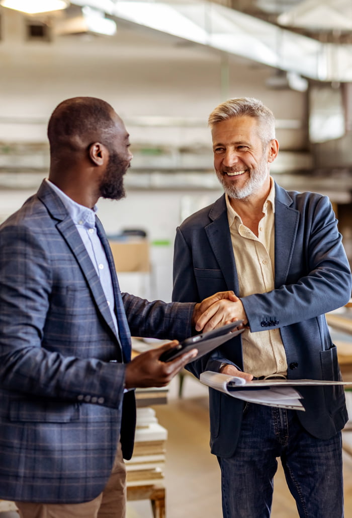 smiling businessmen shaking hands